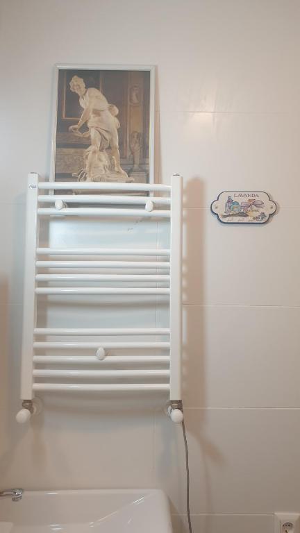 a white refrigerator with a statue on top of it at Mikhail Zandukeli 34 Studio in Tbilisi City