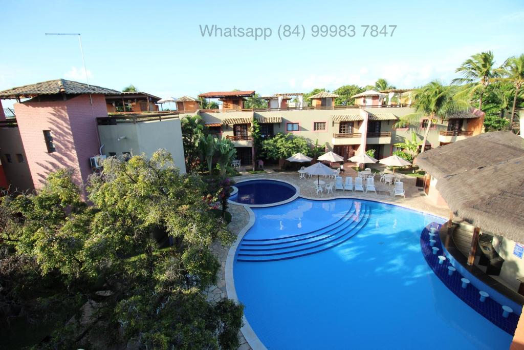 an image of a swimming pool at a resort at Chalé Tulipa - Centro de Pipa - Cond Residencial Resort Pipa in Pipa