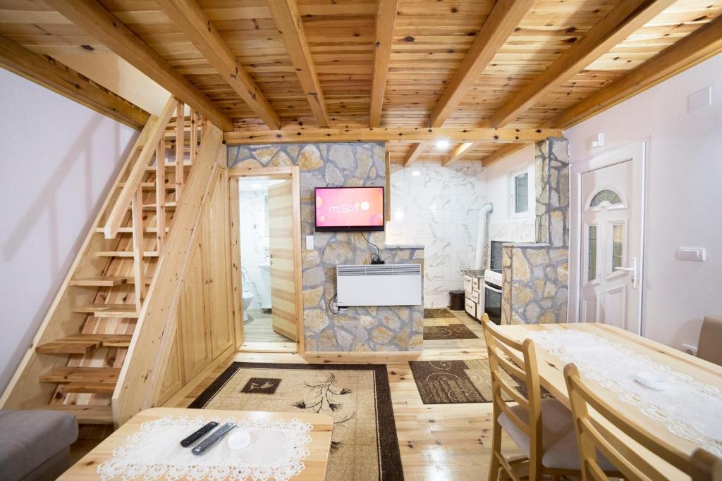 a tiny house with a staircase and a living room at Stojanov Konak in Lazići