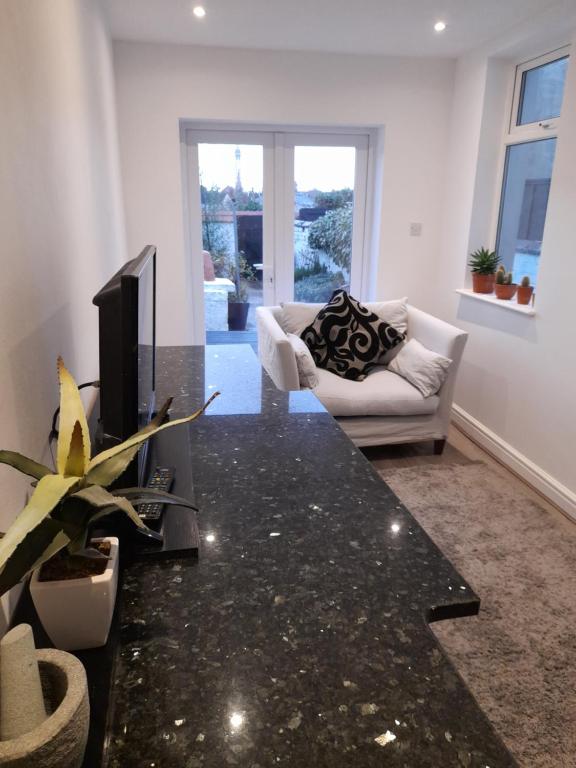 a living room with a tv and a couch at Fabulous terrace cottage in Blackpool