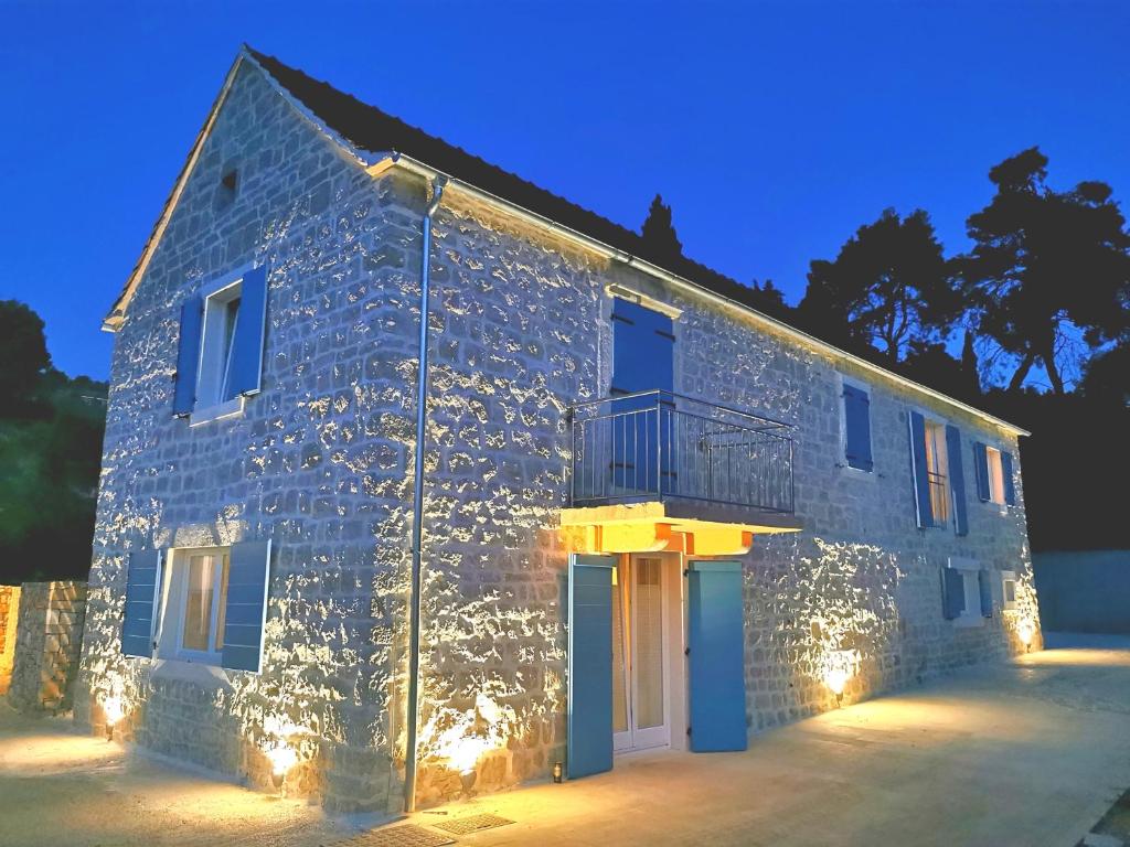 a building with lights on the side of it at EST Villa DIOCLETIAN on Solta - luxurious villa, beachfront, private pool, outdoor BBQ, large terrace and garden, free parking - Wonderful privacy in Rogač