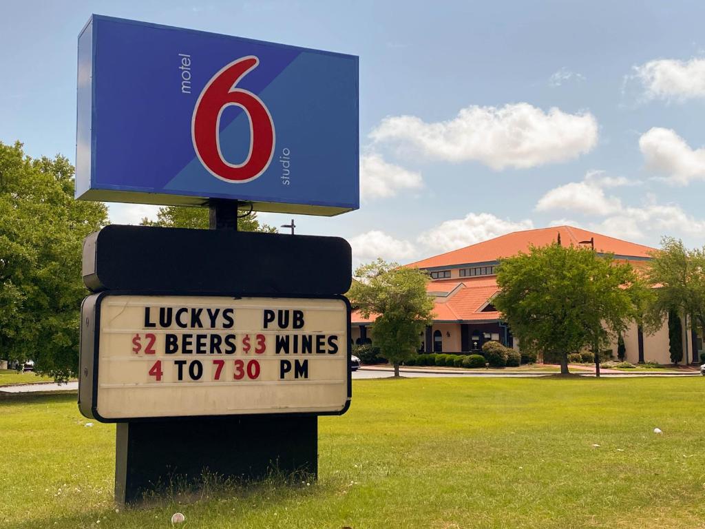 a sign for a ludys pub with a gas pump at Motel 6 Savannah, GA - Gateway & I-95 in Savannah