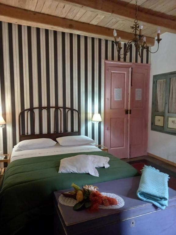 a bedroom with a bed and a table with a plate of food at La Stella in Civita