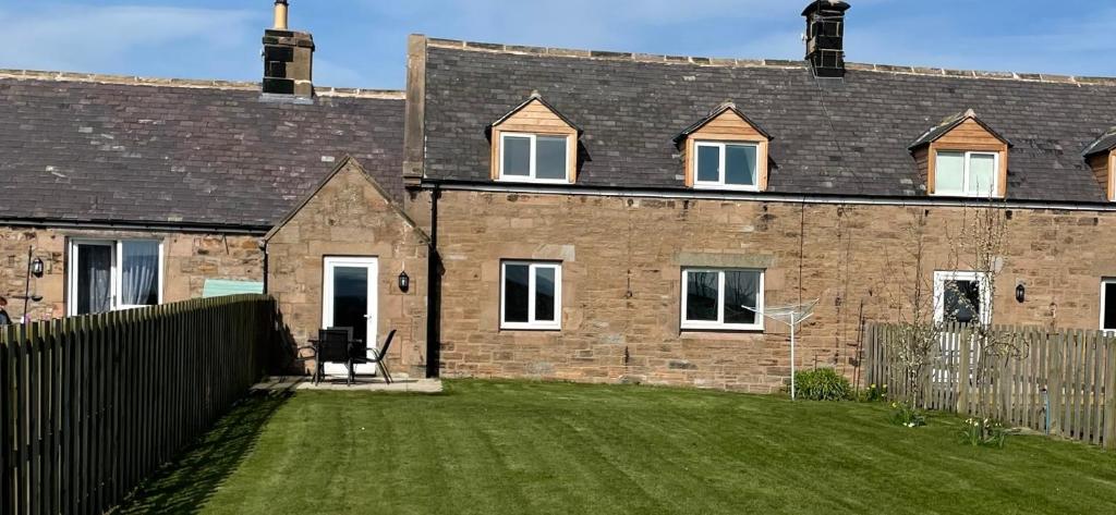 a bedroom house with a yard in front of it at Tweed Cottage 4 Fenton Hill in Wooler