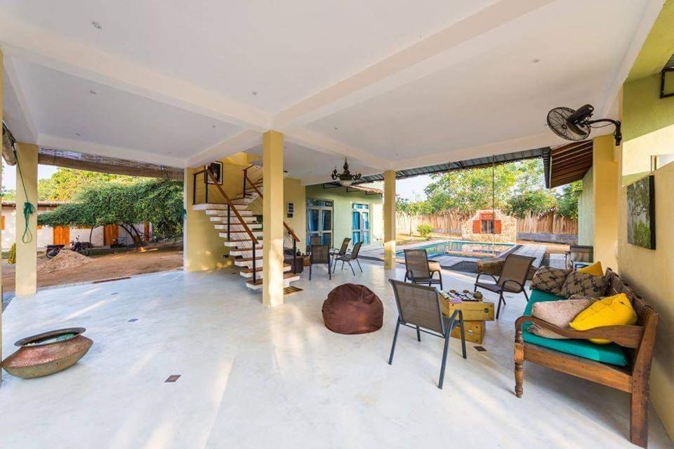 a living room with a staircase leading to a pool at Forestville Yala in Yala