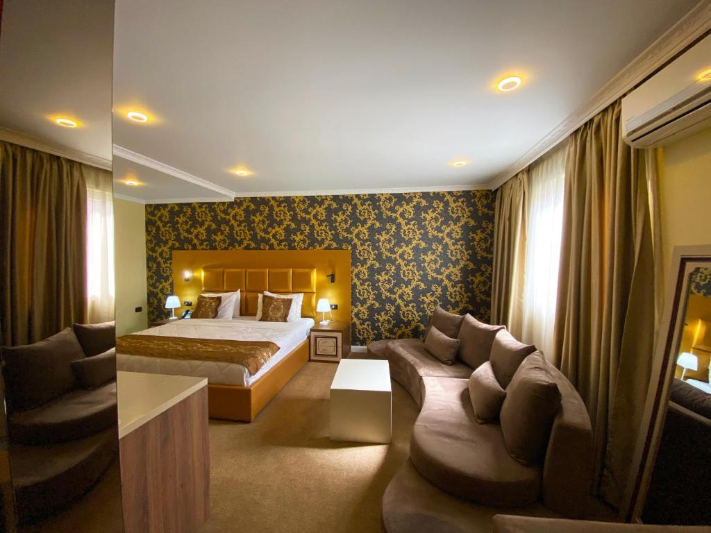 Postel nebo postele na pokoji v ubytování Hotel Deluxe