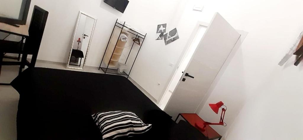 a bedroom with a black and white bed and a staircase at ANDIRIVIENI☆LECCE ☆CASA VACANZE LECCE in Lecce