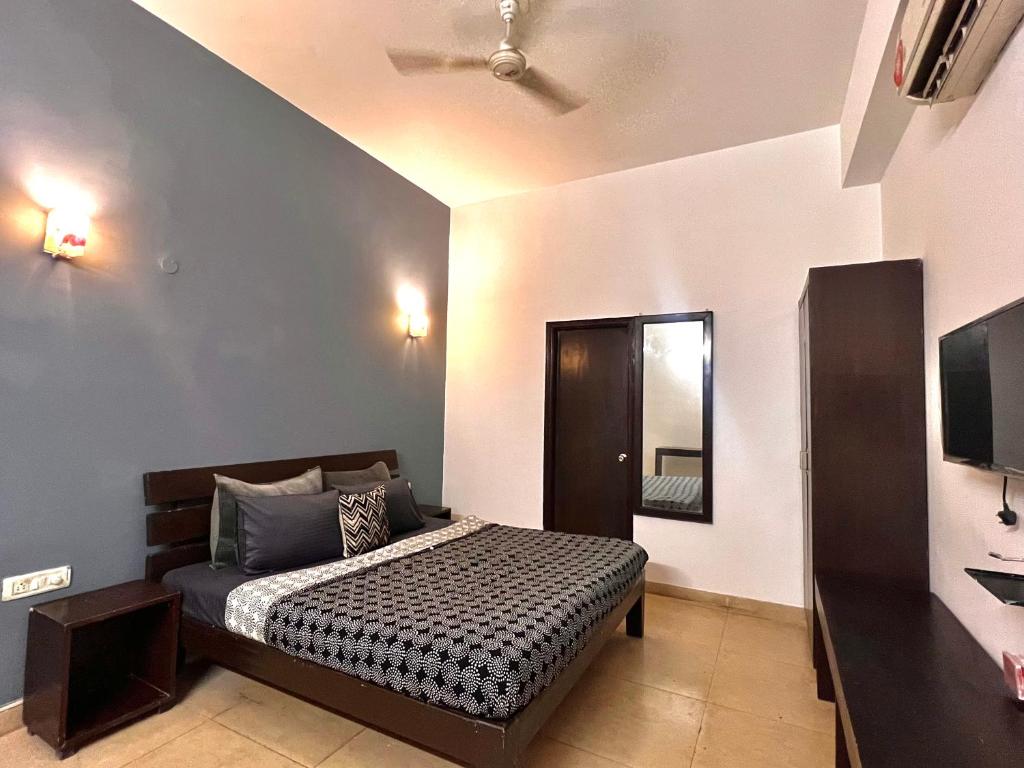 a bedroom with a bed and a mirror at Room with attach washroom on main road- Rajiv Chowk Gurgaon in Gurgaon