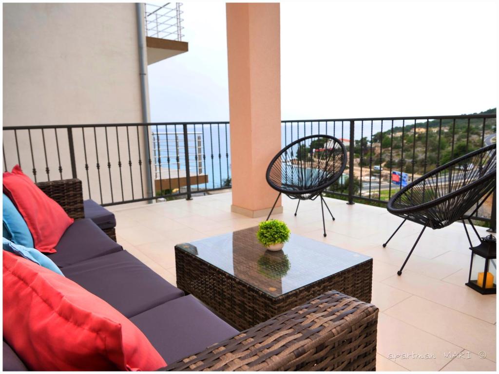 a living room with a couch and a table on a balcony at MARI in Dolac
