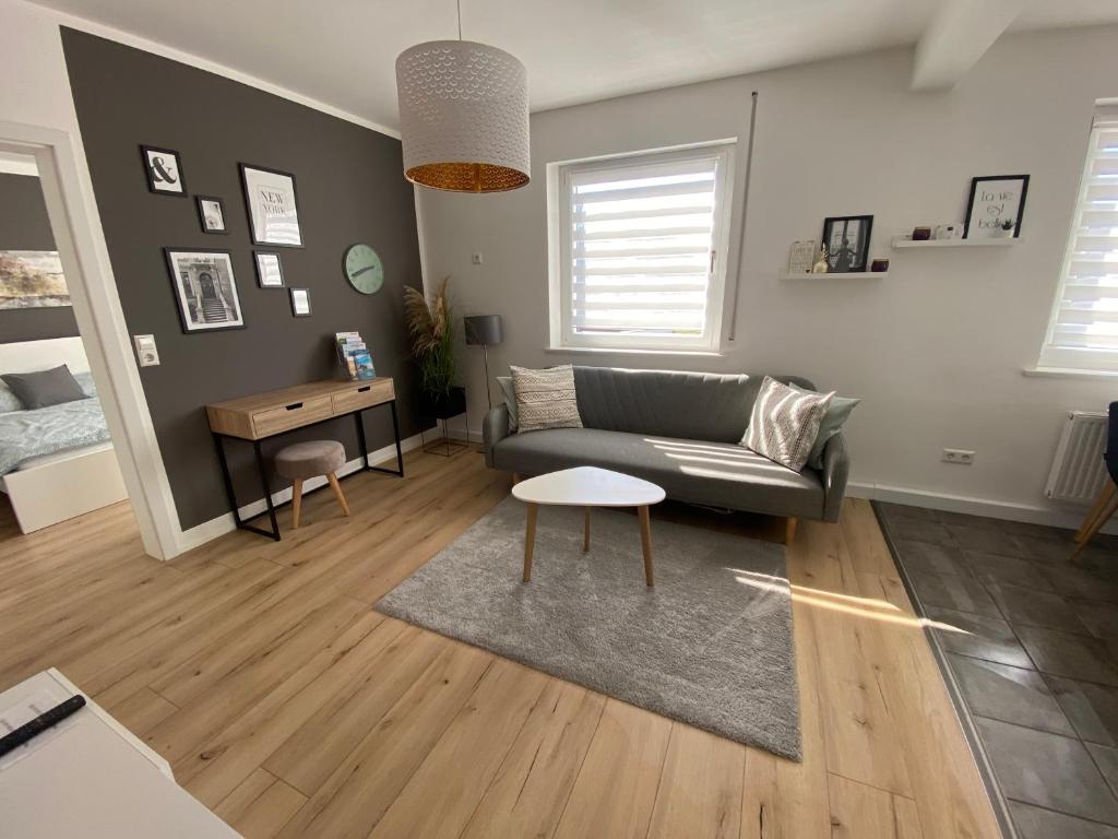 a living room with a couch and a table at Apartment Friedrichshafen Center in Friedrichshafen