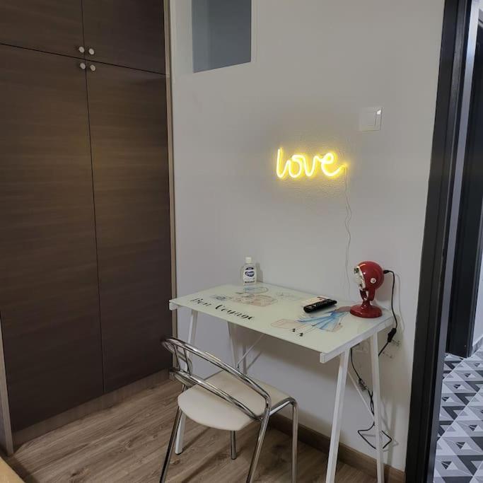 una mesa blanca con una señal que dice amor en una pared en COSY APARTMENT IN VERIA, en Veria