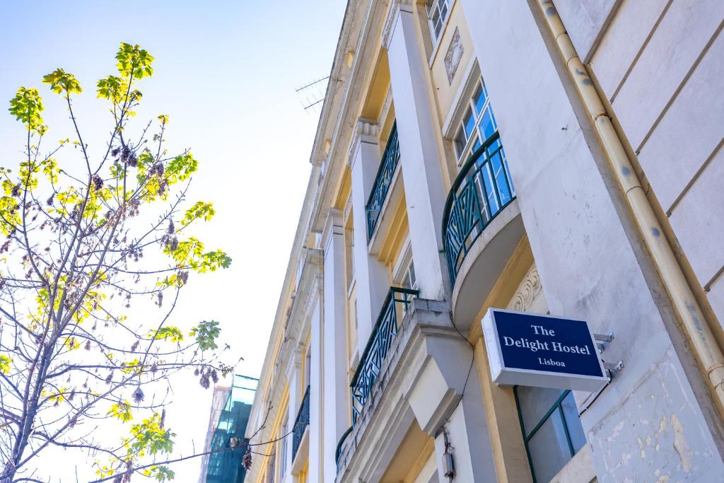 a sign on the side of a building at The Delight Hostel in Lisbon