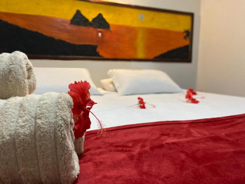 a bed with red bows on top of it at Pousada São Silmares in Fernando de Noronha