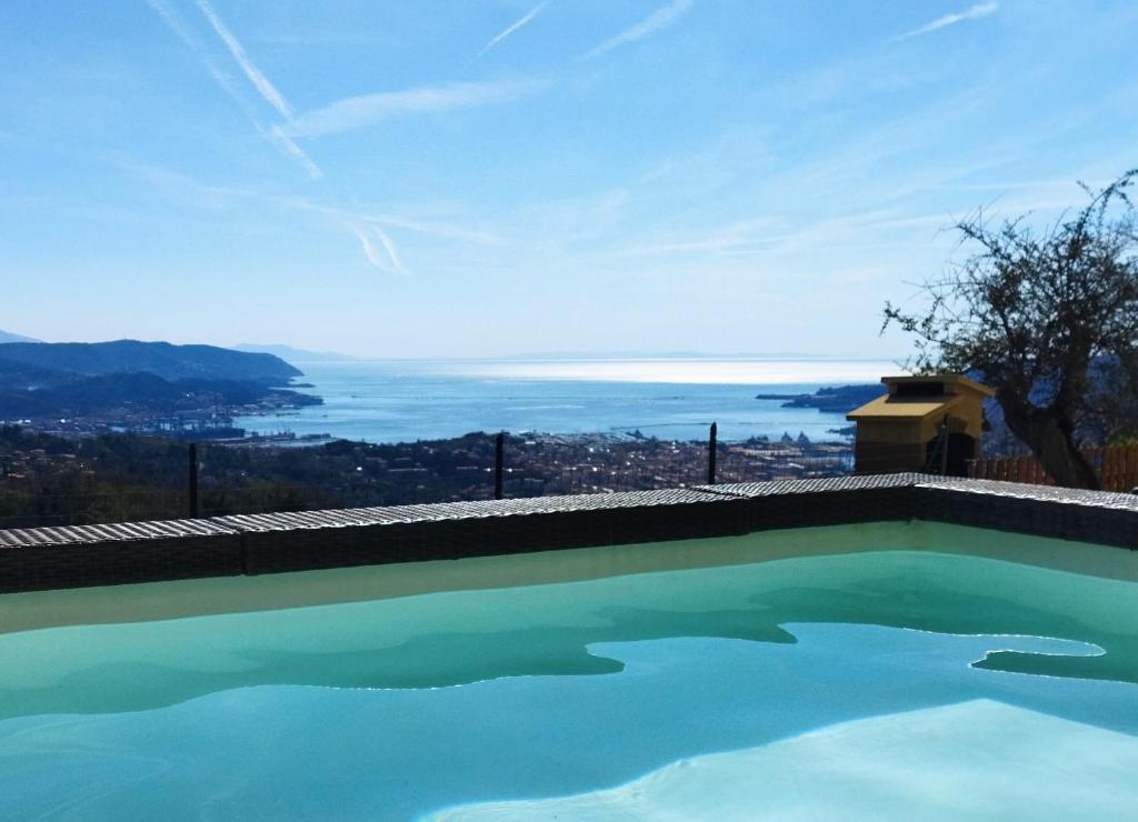 a swimming pool with a view of the ocean at AMPHIORAMA in La Spezia