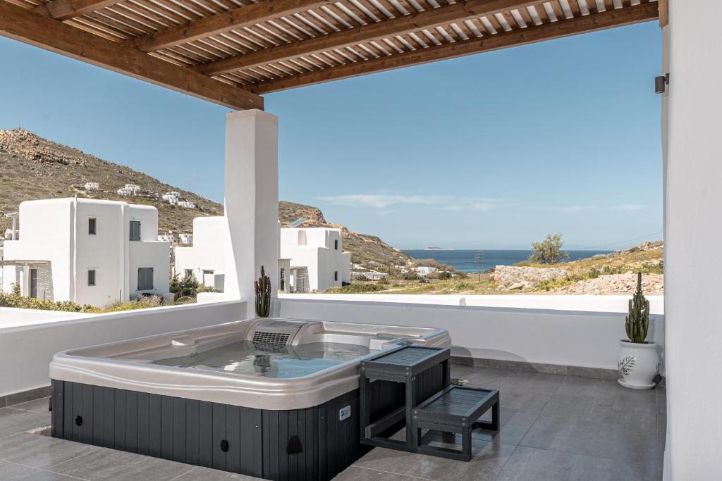 a hot tub on the balcony of a house at Casa Aelia ,Stelida Naxos in Stelida