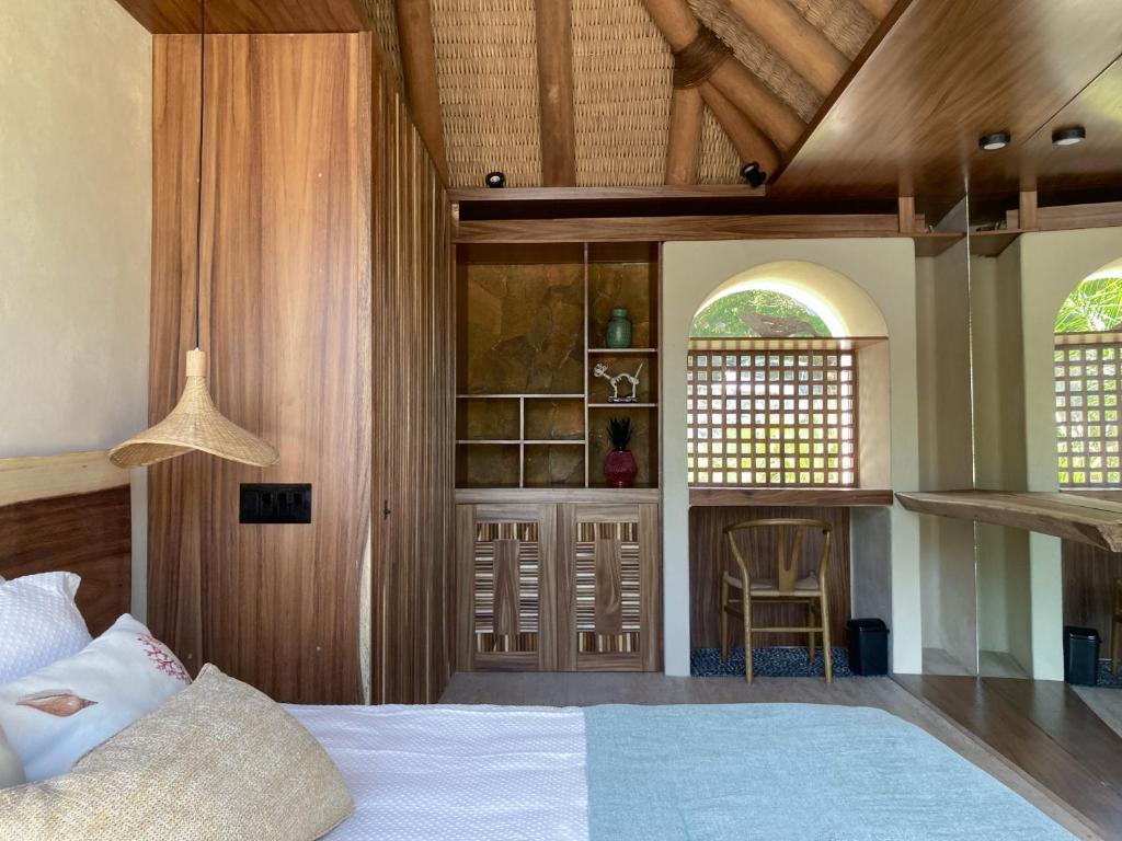 a bedroom with a bed and a staircase and two windows at Villa Marina Ixtapa in Ixtapa