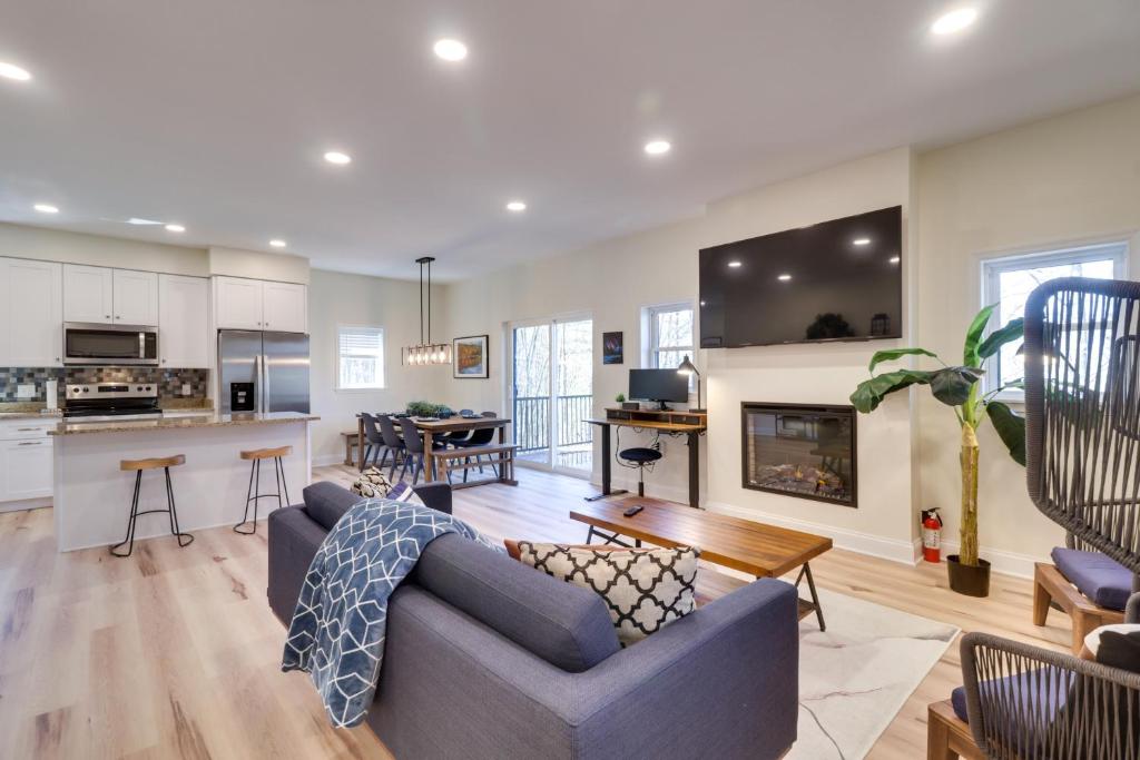a living room with a couch and a kitchen at Pet-Friendly Basye Vacation Rental with Fireplace! in Basye