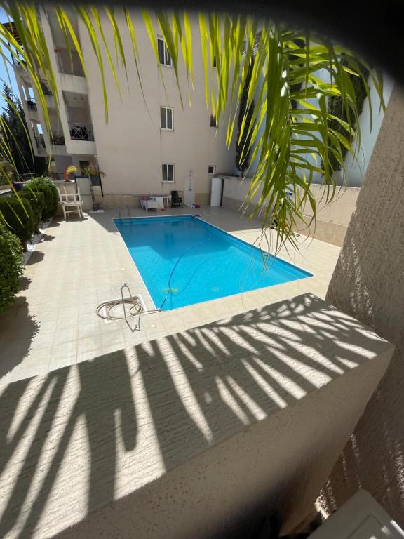 a swimming pool in front of a building at Belleview Heights in Limassol