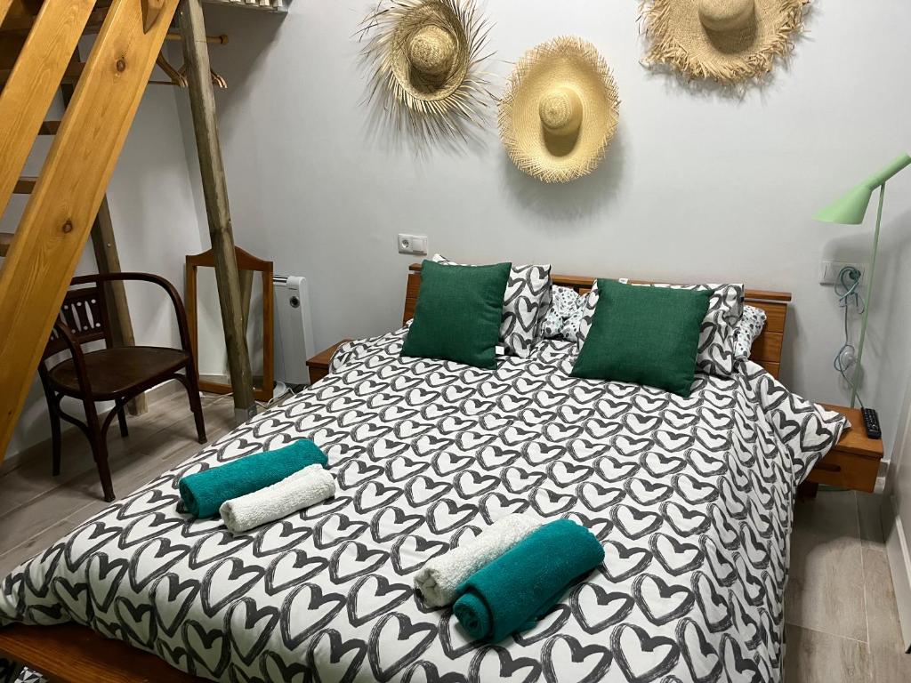 a bedroom with a bed with pillows on it at Alzira bonita Habitación verde con baño privado in Alzira