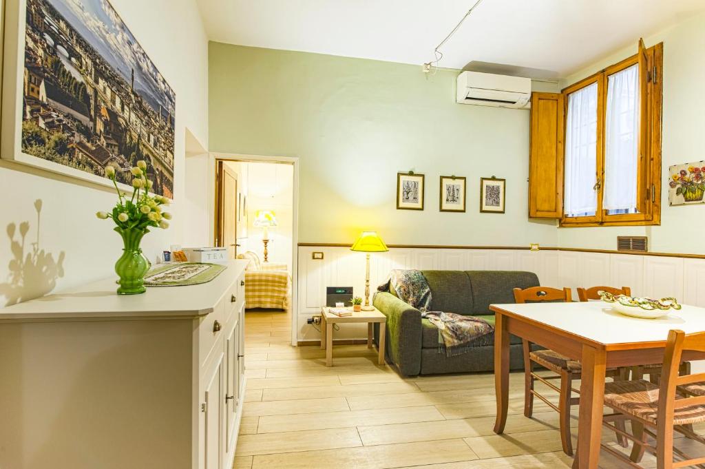 a kitchen and living room with a couch and a table at The Heart of Florence in Florence