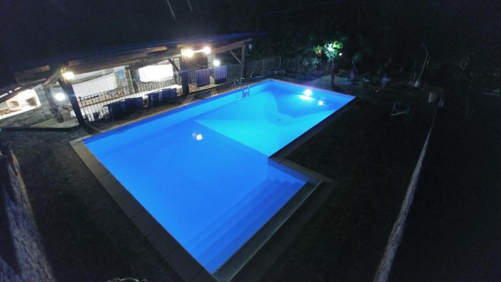 a swimming pool at night with blue lights at Casa San Quirico Agnone in Agnone