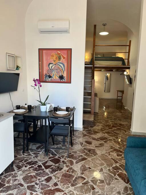 a living room with a table and a couch at Casa vacanze Piazza San Pietro in Bari