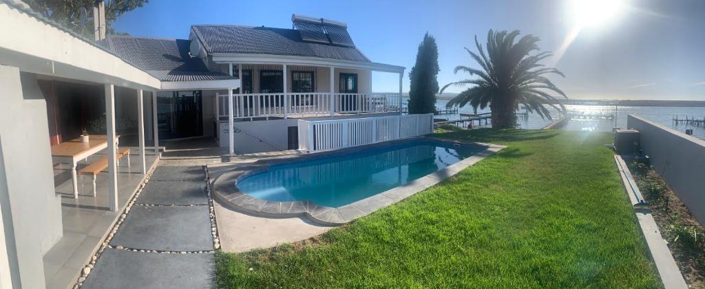 a house with a swimming pool next to the ocean at Berg River Living in Velddrif