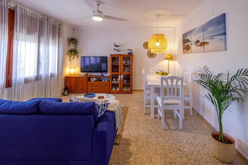 a living room with a blue couch and a table at Apartamentos Maruja Roig 1 Playa Sur in Peniscola