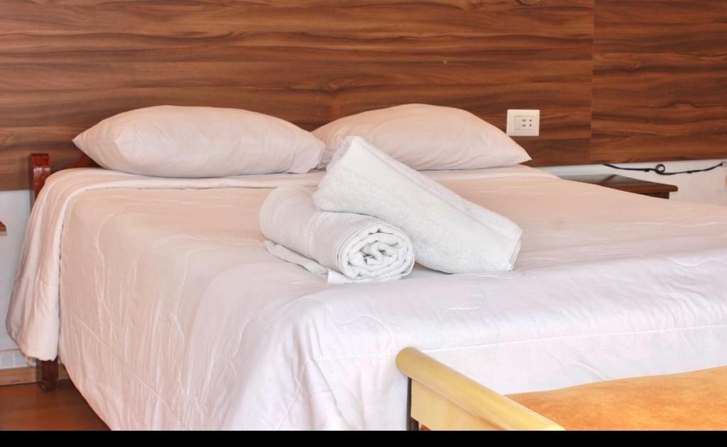Postel nebo postele na pokoji v ubytování SAN BLAS PLAZA INn
