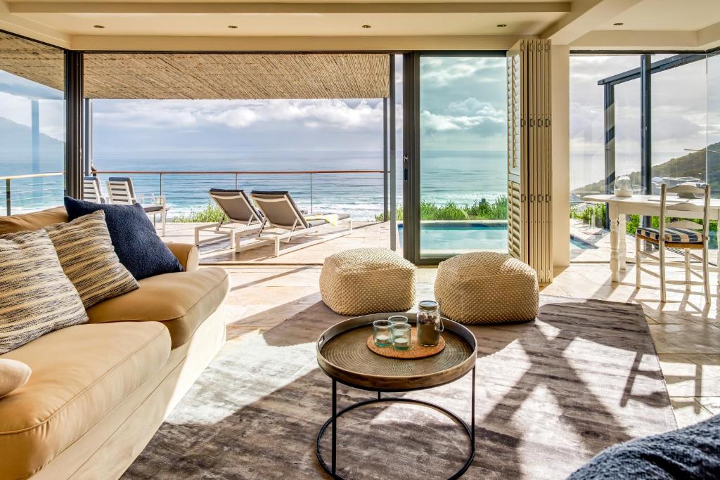 a living room with a couch and a table at Ocean's Horizon Beach House in Scarborough