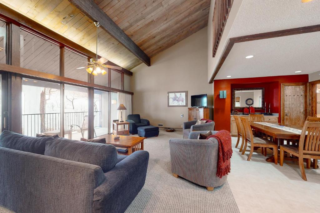 a living room with couches and a dining room at Tamarron Lodge Escape in Durango