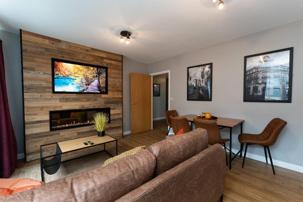 a living room with a couch and a fireplace at High Street Town House in Manchester