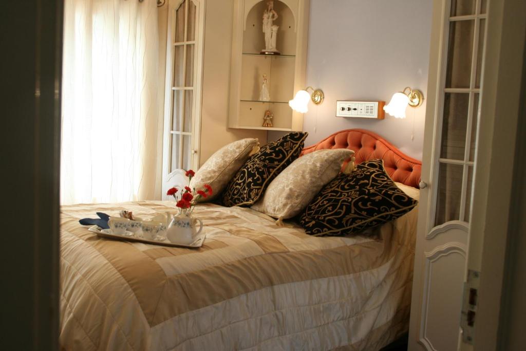 a bedroom with a bed with pillows and a window at Lyme Bay House in Dawlish