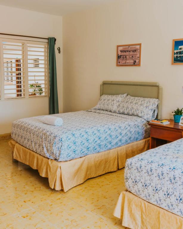 Postel nebo postele na pokoji v ubytování Casa Chetumal Hotel