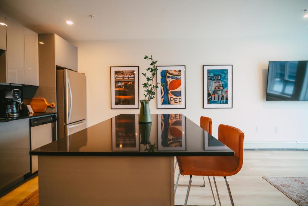 a kitchen with a glass counter top and a refrigerator at NEW Stylish 2BR Condo with Views in North End in Halifax