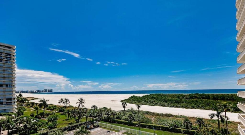 a view of the beach from the balcony of a building at Beachfront I Full Coastal Contemporary Renovation in Marco Island