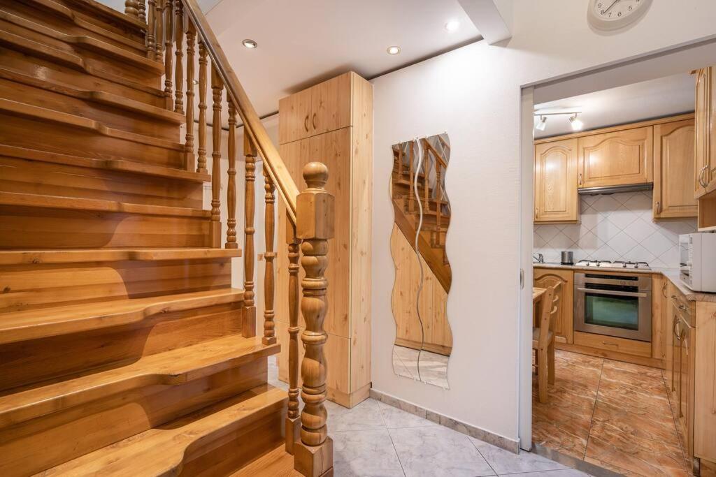 a kitchen with wooden stairs in a home at Cozy 3 bedrooms in 7st districht in Budapest