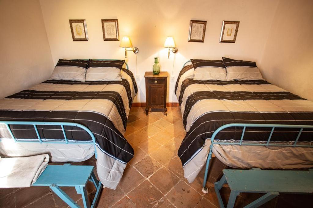 a room with two beds and a table in it at Cabaña Filiberta de Lucas 