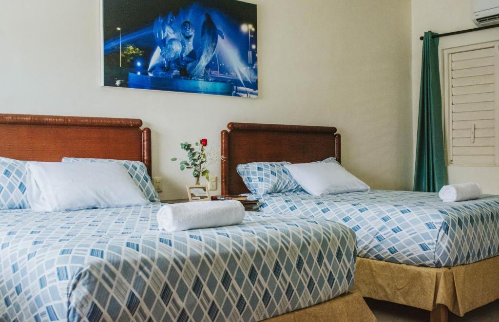 Postel nebo postele na pokoji v ubytování Casa Chetumal Hotel