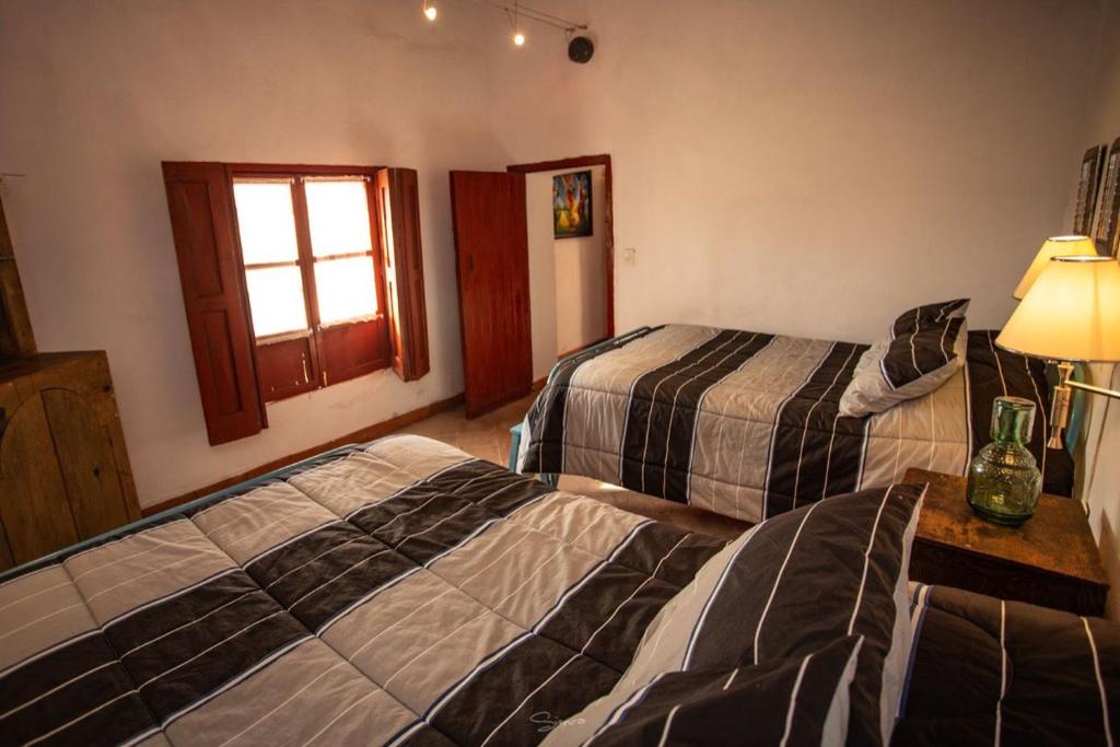 a hotel room with two beds and a window at Cabaña Corazon de Calixto 
