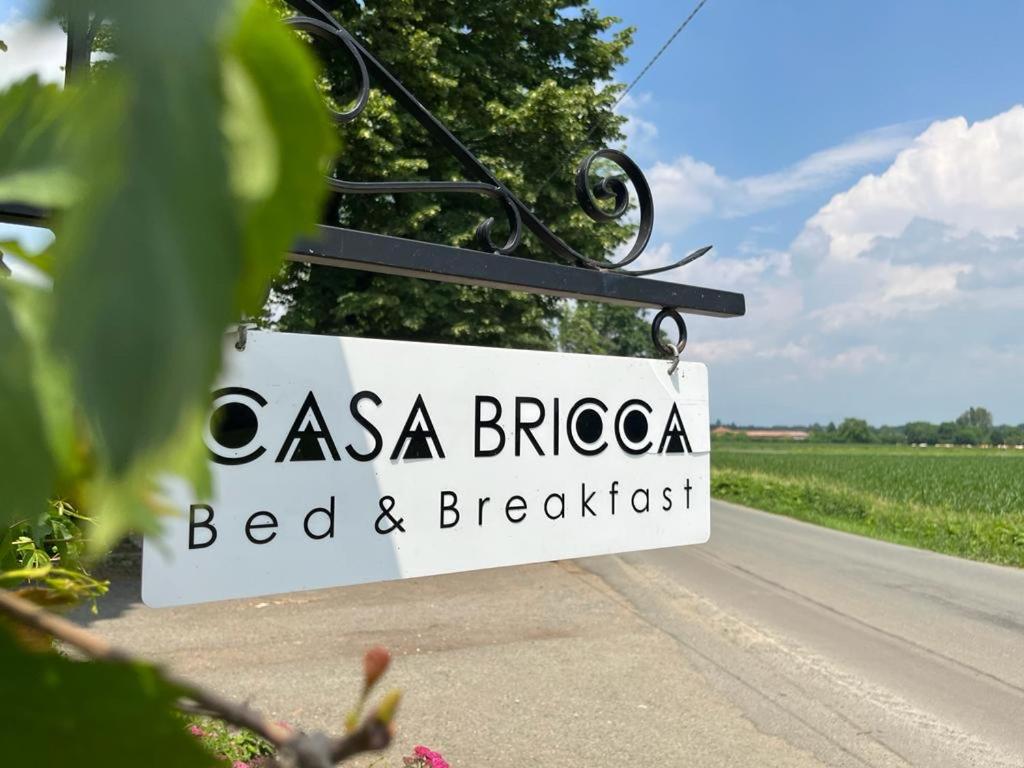 a sign for a bed and breakfast next to a road at Casa Bricca in Pianezza