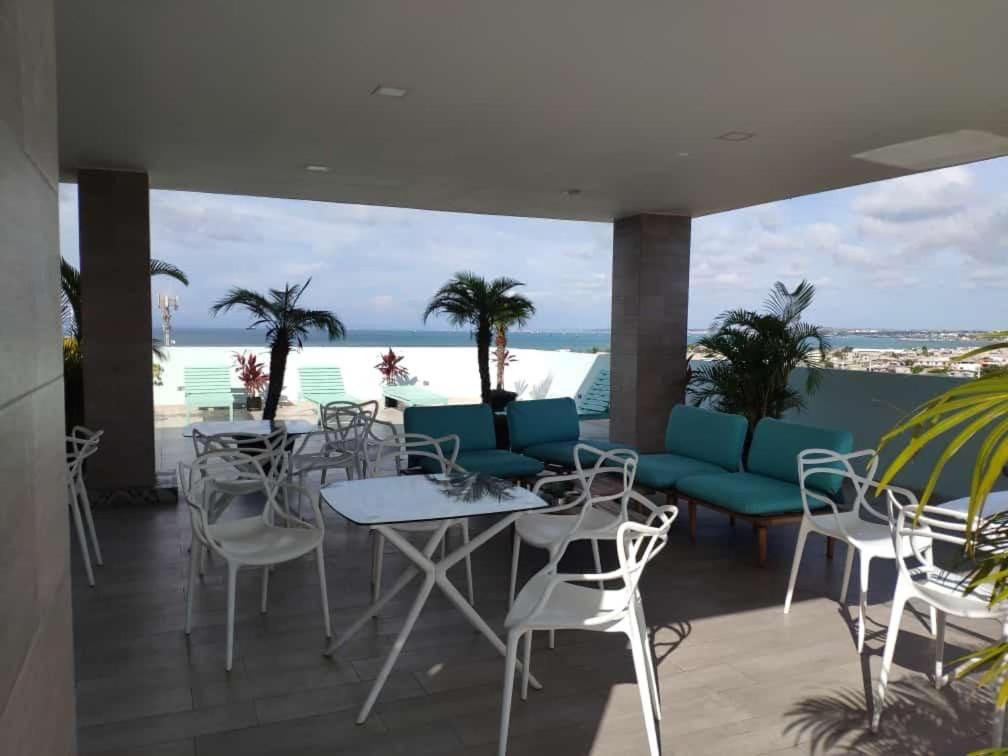 a patio with tables and chairs and a view of the beach at Salinas Bay Suite in Salinas
