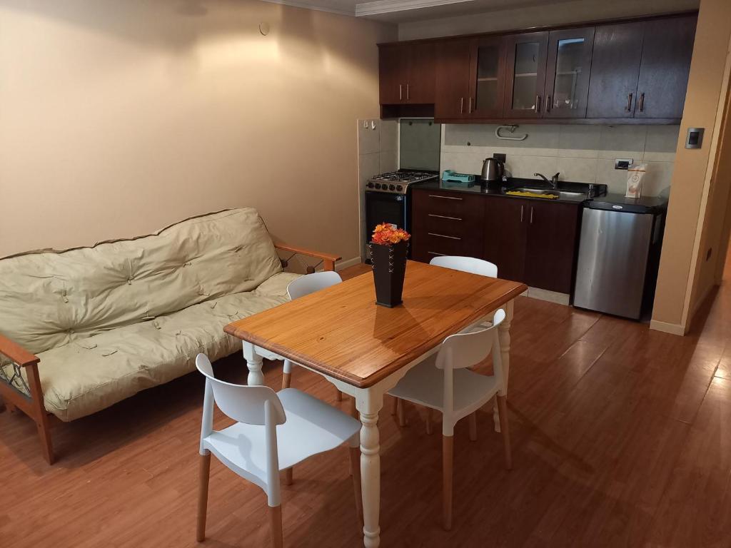 a living room with a table and a couch at Departamento Residencial in San Fernando del Valle de Catamarca