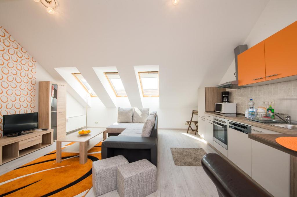 a kitchen and living room in a loft with skylights at Budapest Center Executive Apartments in Budapest
