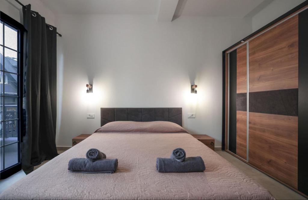 a bedroom with a bed with two towels on it at Sogni D' Oro "Zen" in Zakynthos Town