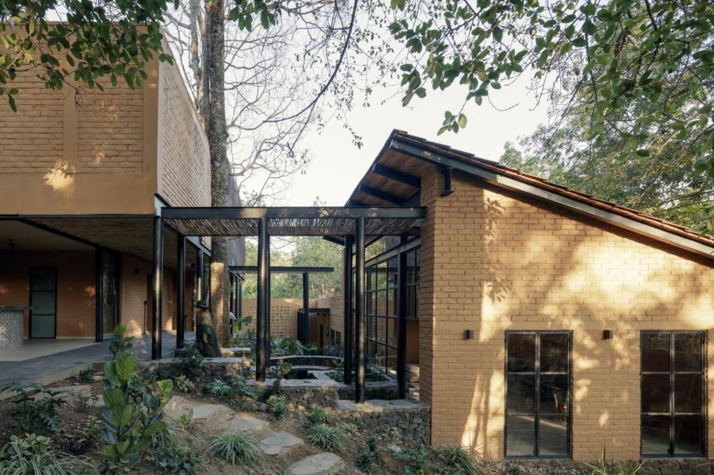 a brick house with glass doors and windows at Casa Patio in San Sebastián del Oeste