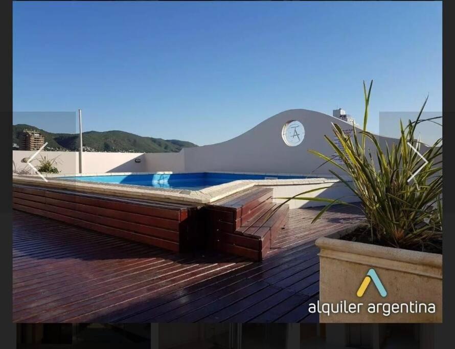 una piscina en la parte superior de una terraza de madera en Depto Centro de Carlos Paz en Villa Carlos Paz