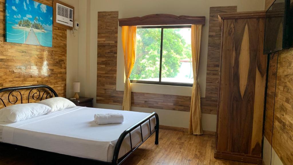 Postel nebo postele na pokoji v ubytování Mabini Hotel