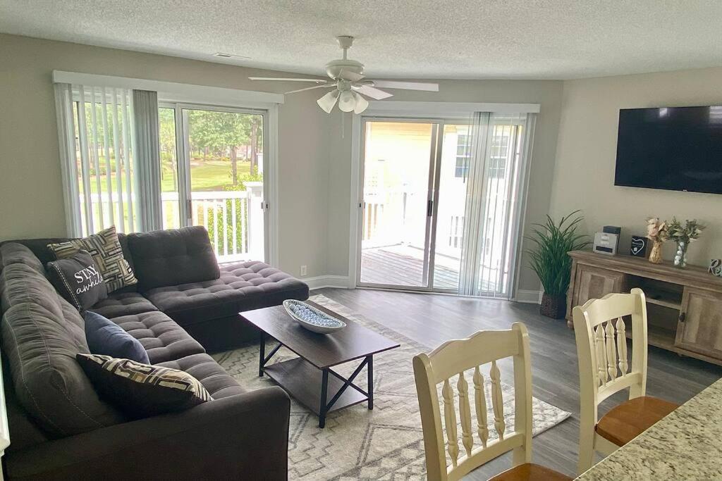 a living room with a couch and a table at Third Floor Score in Calabash