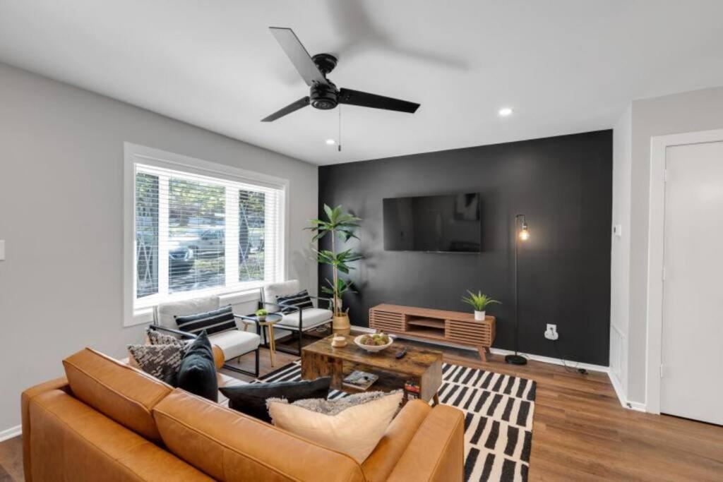 a living room with a couch and a ceiling fan at 3 Mi to City & Pet Friendly & Quiet Neighborhood in Charlotte
